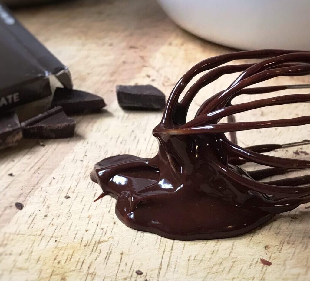 wish covered in melted chocolate pooling onto wood board