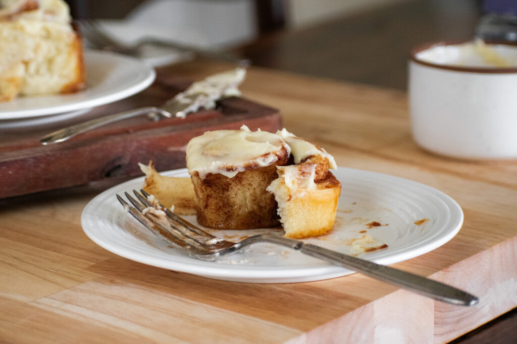 plate of single sourdough cinnamon roll partially eaten