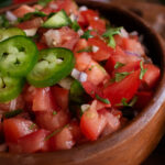 close up shot of pico de gala in a wooden bowl