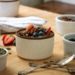 chia seed pudding in a white ramekin with fresh fruit on top