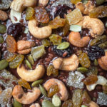 unclose overhead shot of melted chocolate Coates with nuts, seeds, and dried fruit